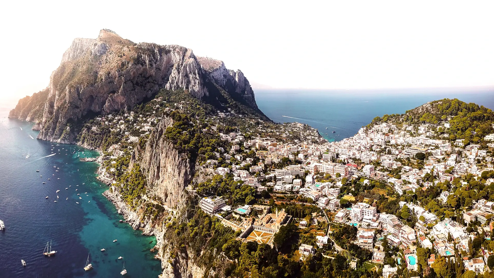 The island of Capri seen from above with its coastline and harbor, Campania, Italy
